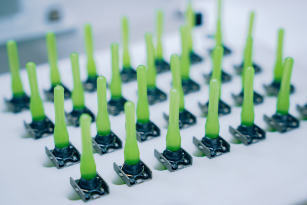 Adhesive-bonded fasteners prepared for installation using Click Bond’s Automated Bonding Technology.