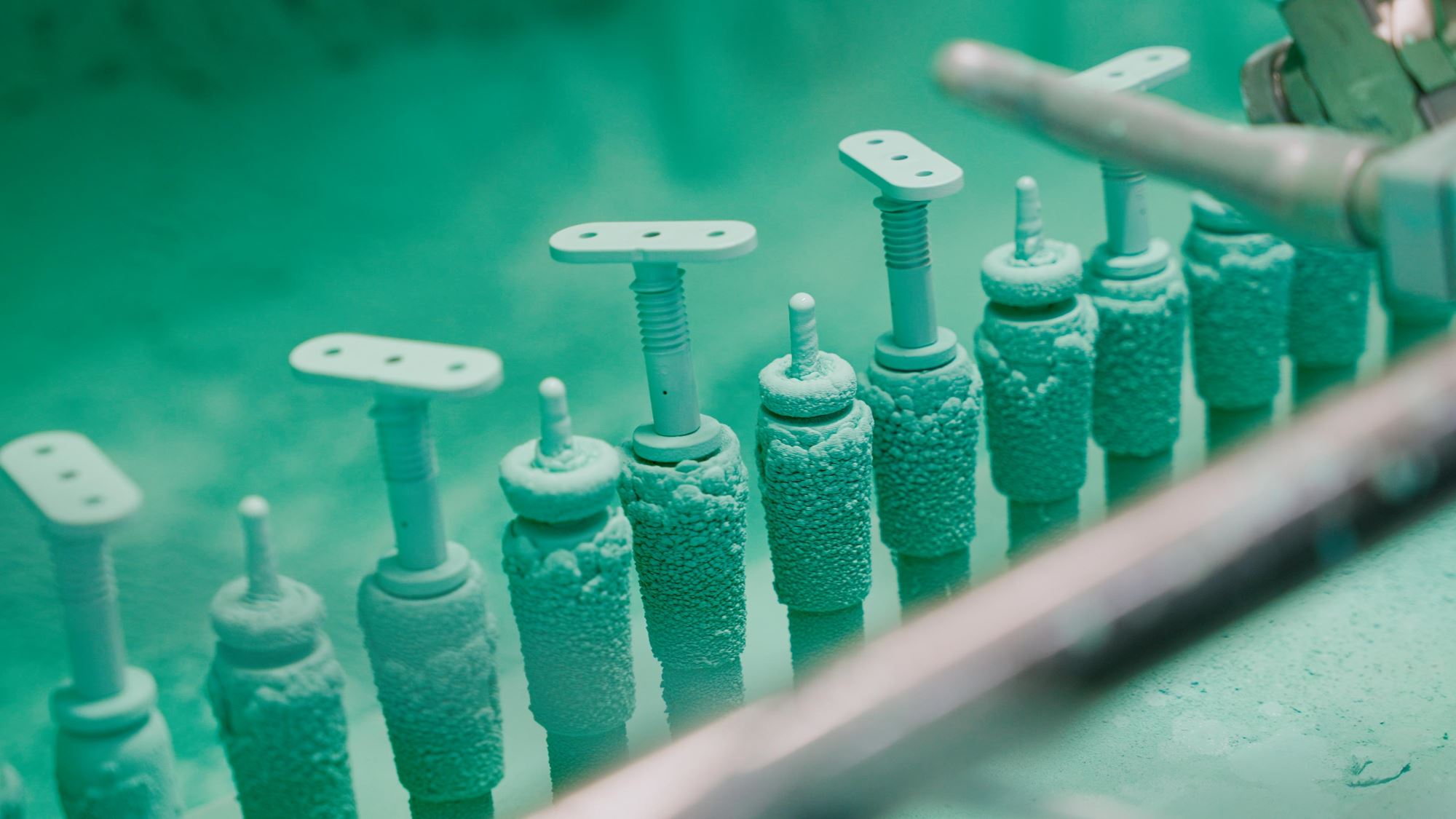 Adhesive-bonded fasteners undergoing precision coating process at Click Bond’s advanced manufacturing facility, ensuring consistent adhesion and corrosion protection.