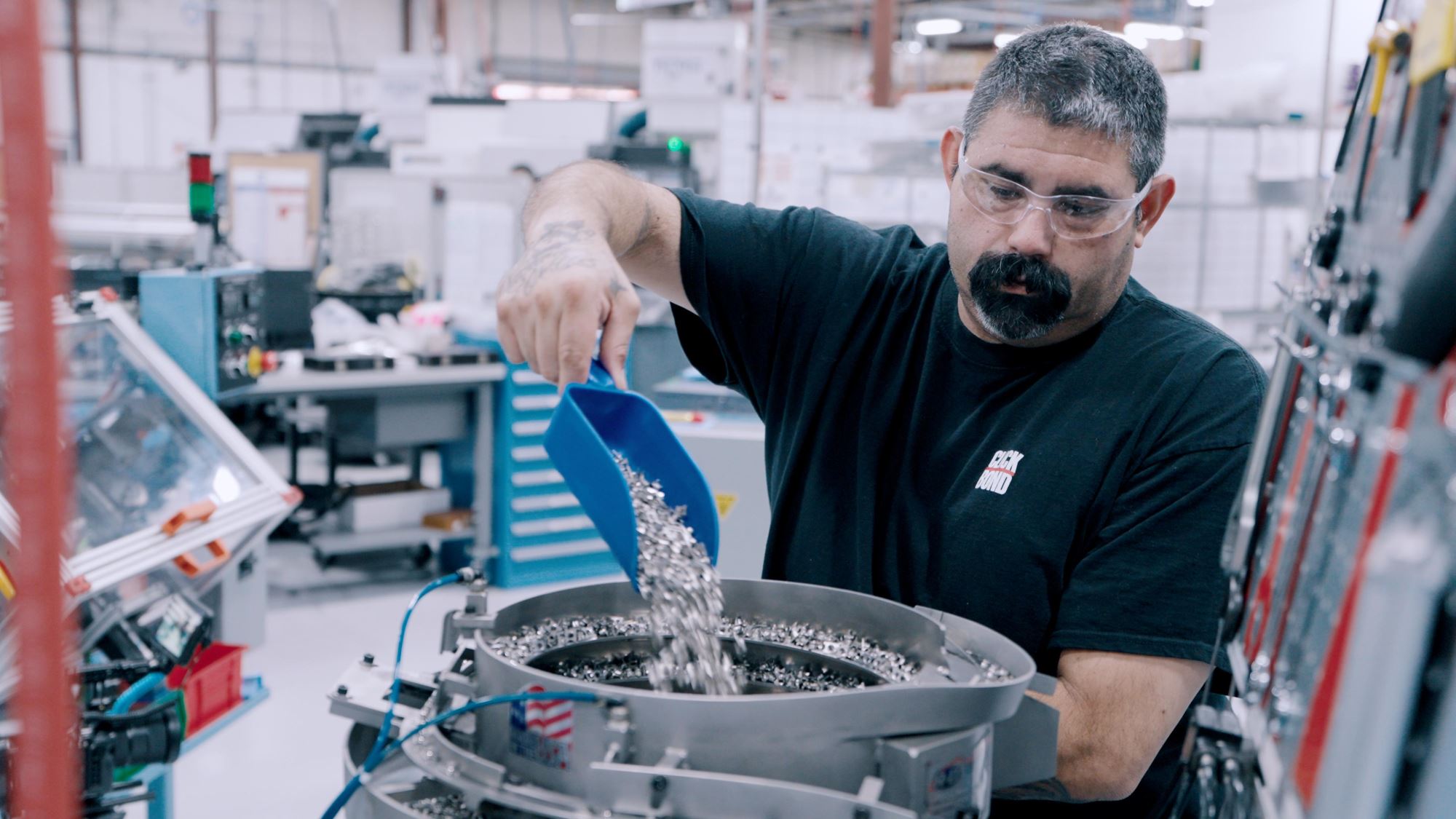 Click Bond operator managing adhesive fastener components during production, emphasizing craftsmanship and quality control in bonded manufacturing.