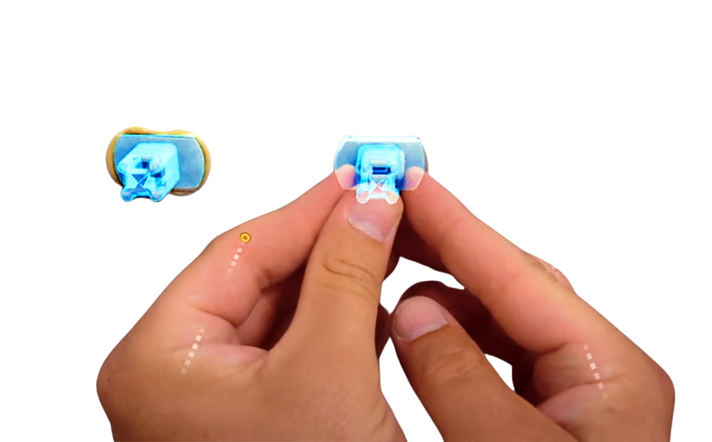 A bonded fastener held between two fingers with a blue augmented-reality overlay marking the install point and tracked data points
